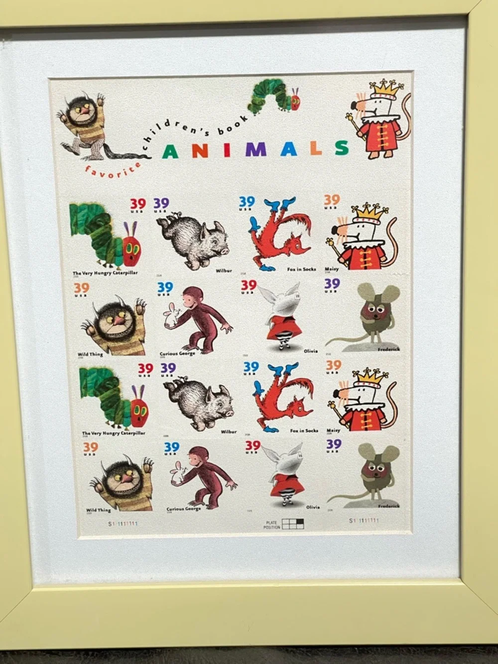 Framed postage stamps of children’s books. Frame soft yellow